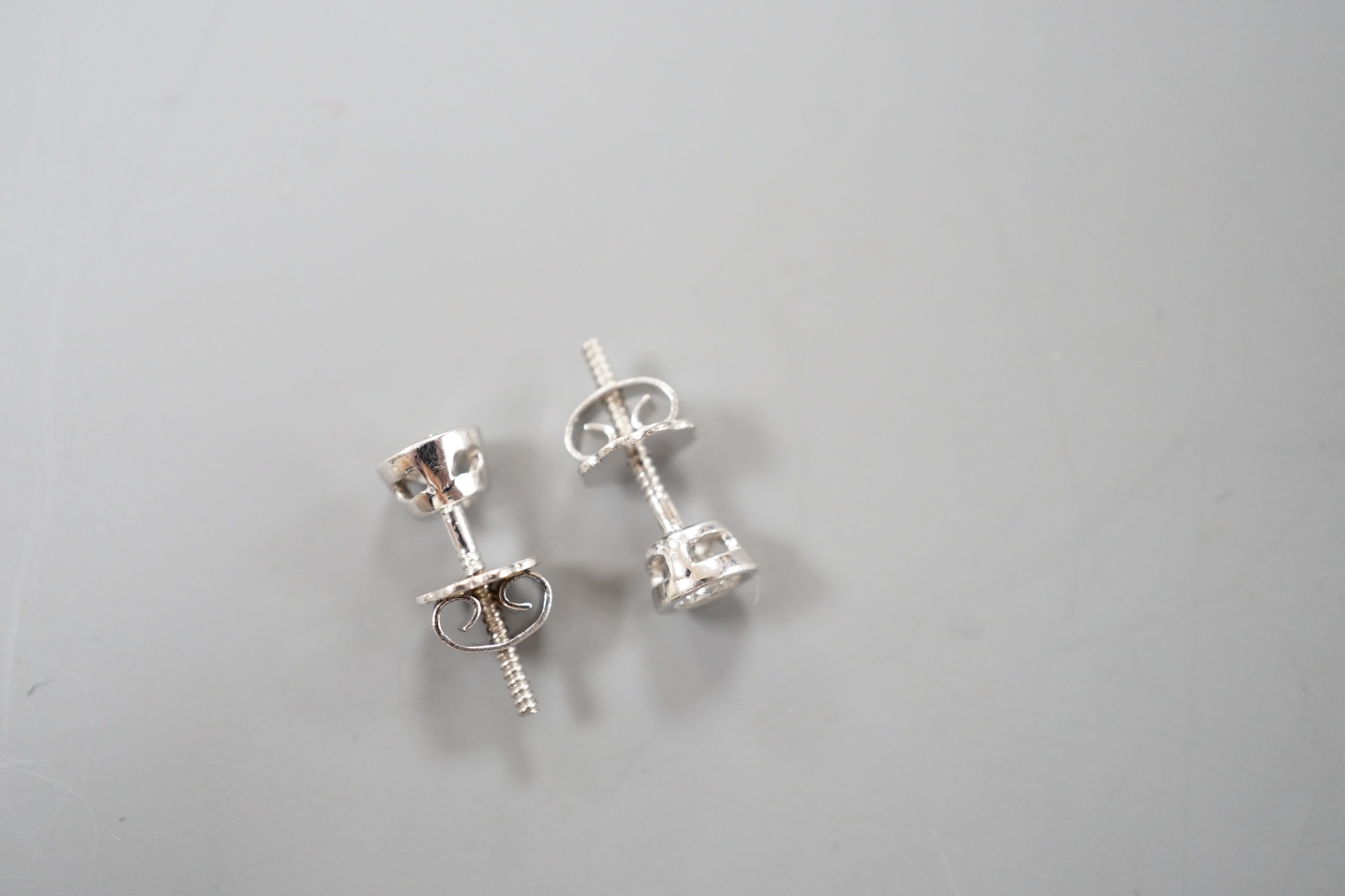 A pair of 750 white metal and collet set solitaire diamond ear studs, gross weight 1.5 grams, stone diameter approx. 3.7mm.